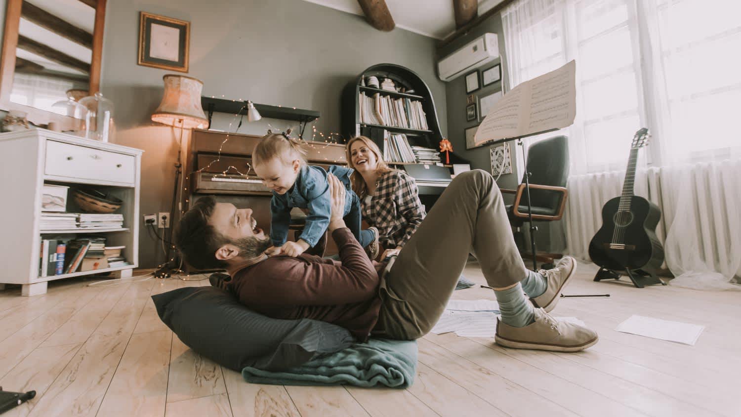 Happy family playing on the floor
