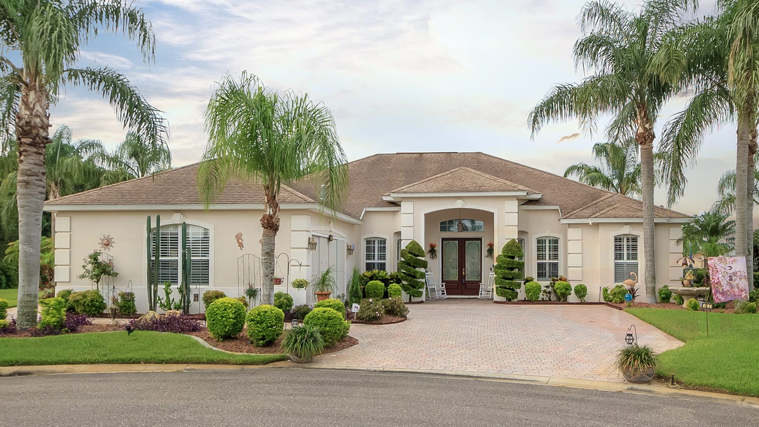 Home with palm trees around exterior