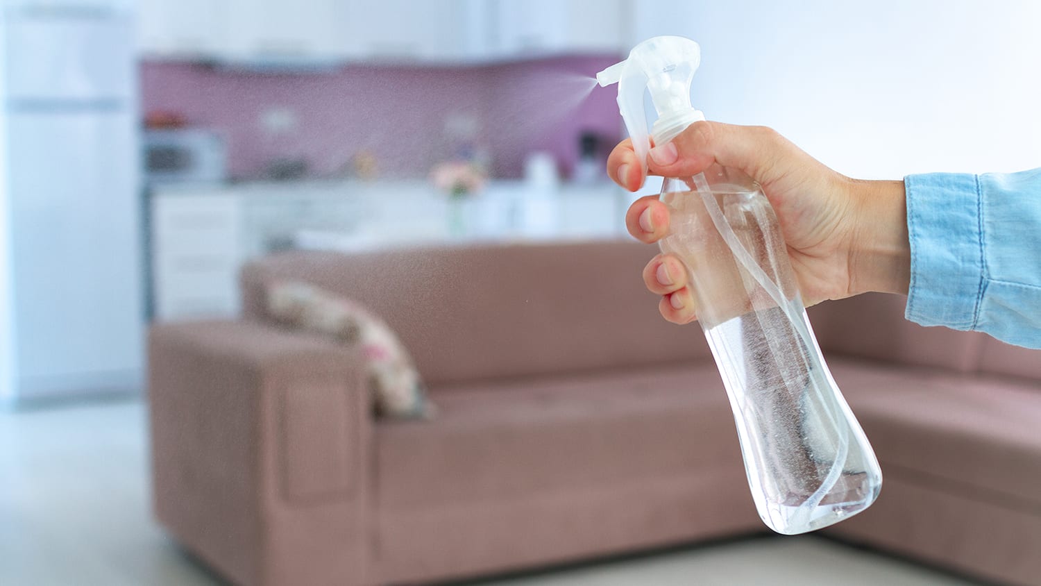 Person spraying essential oil to deter pests