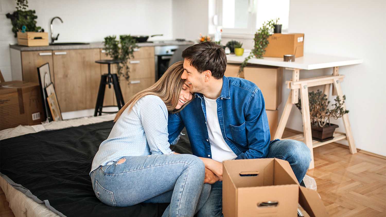 couple hugging settling into their new home