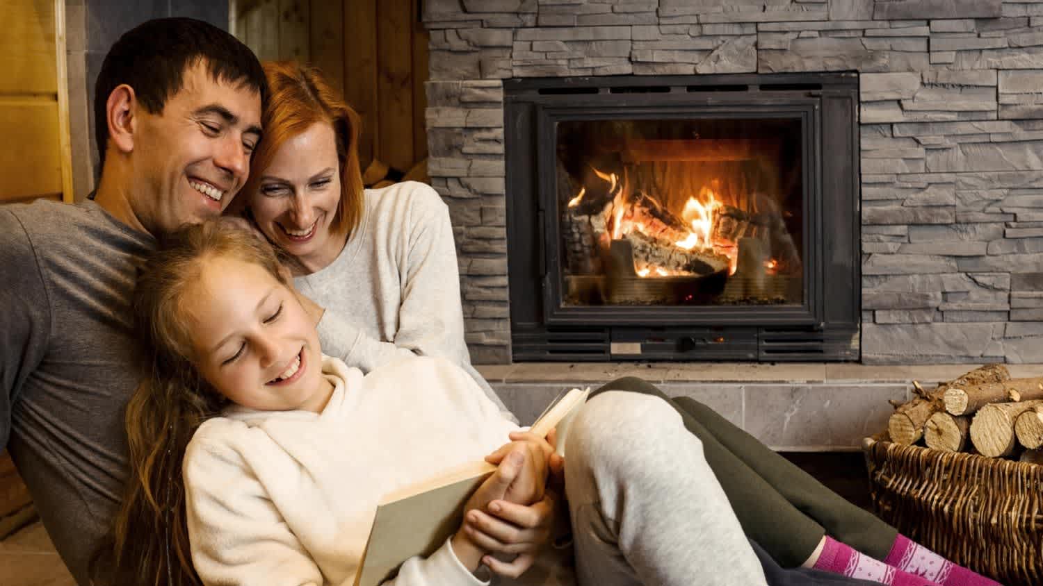family reading together by fireplace