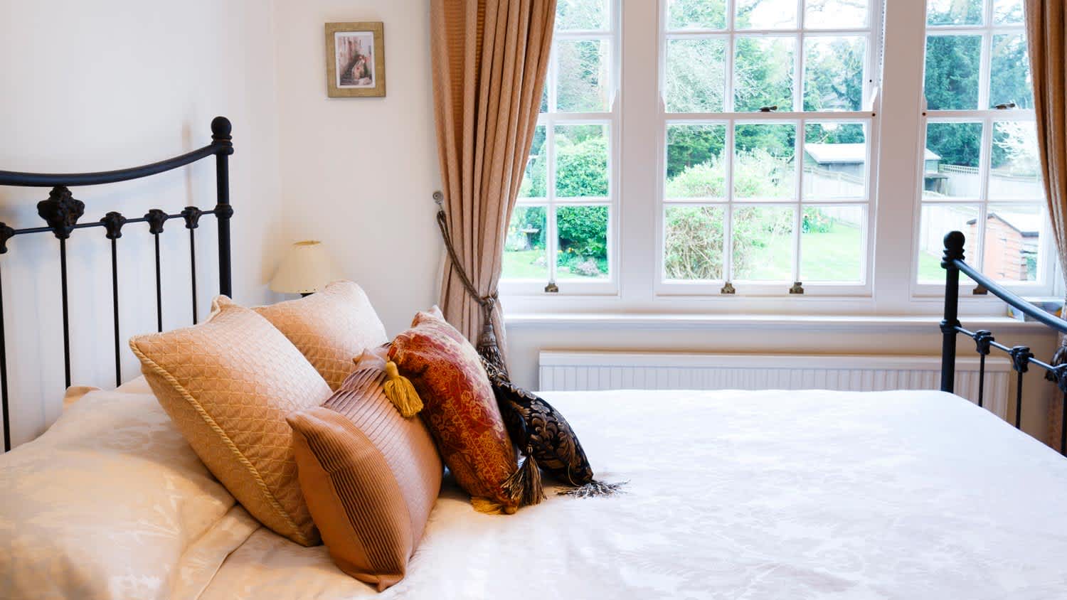 A traditional bedroom with views of nature from the window
