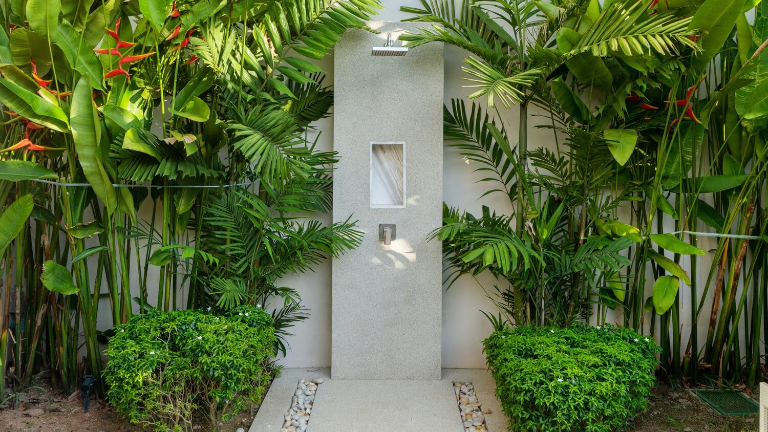 A luxurious outdoor shower in a lush garden