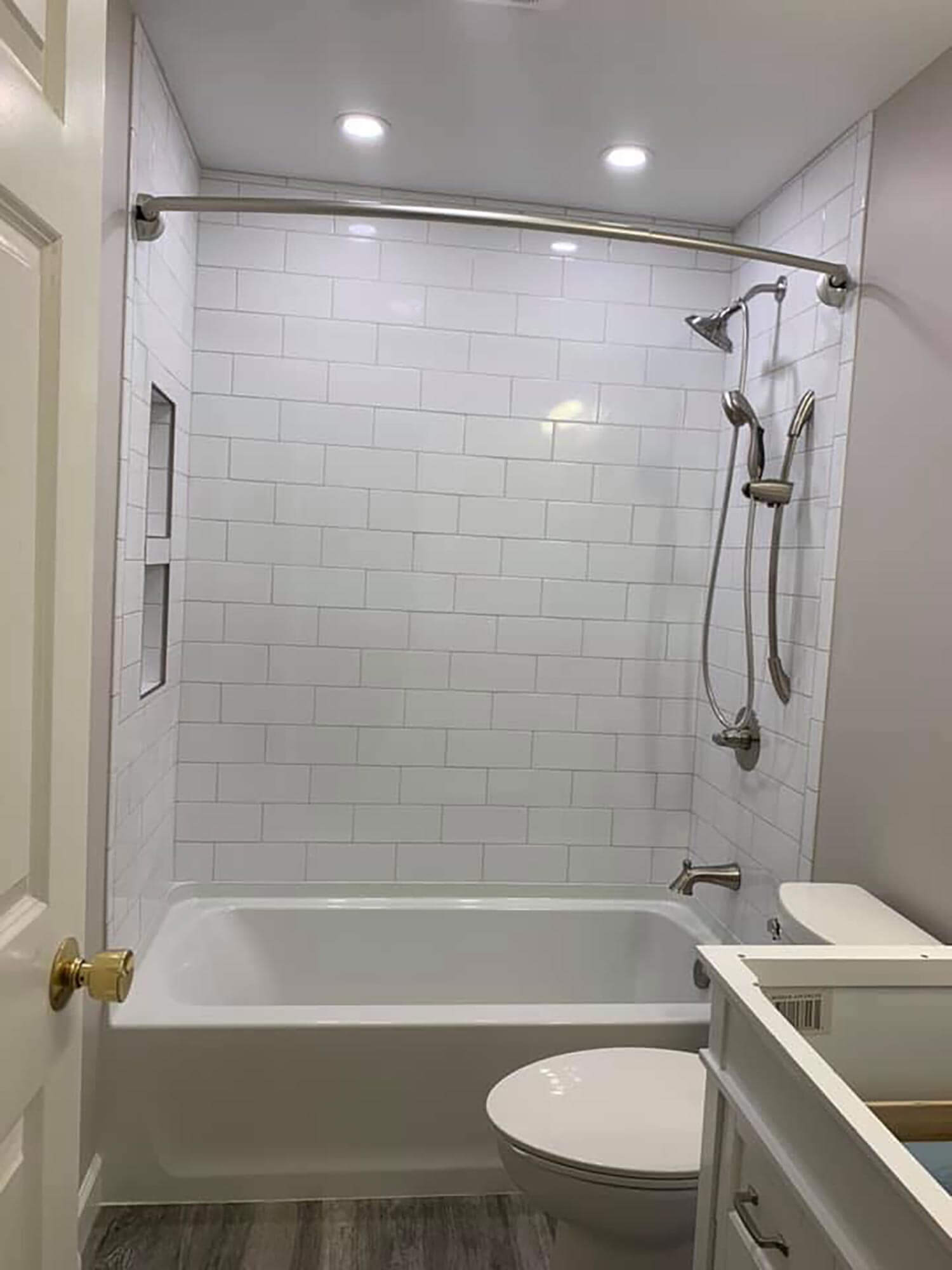A bathtub with classic subway tile