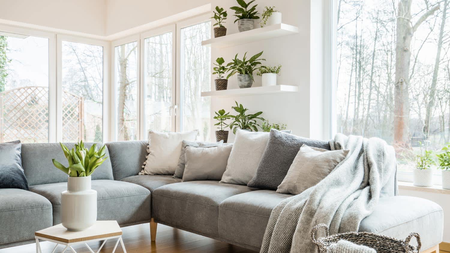 The interior of a living room with a large gray corner sofa