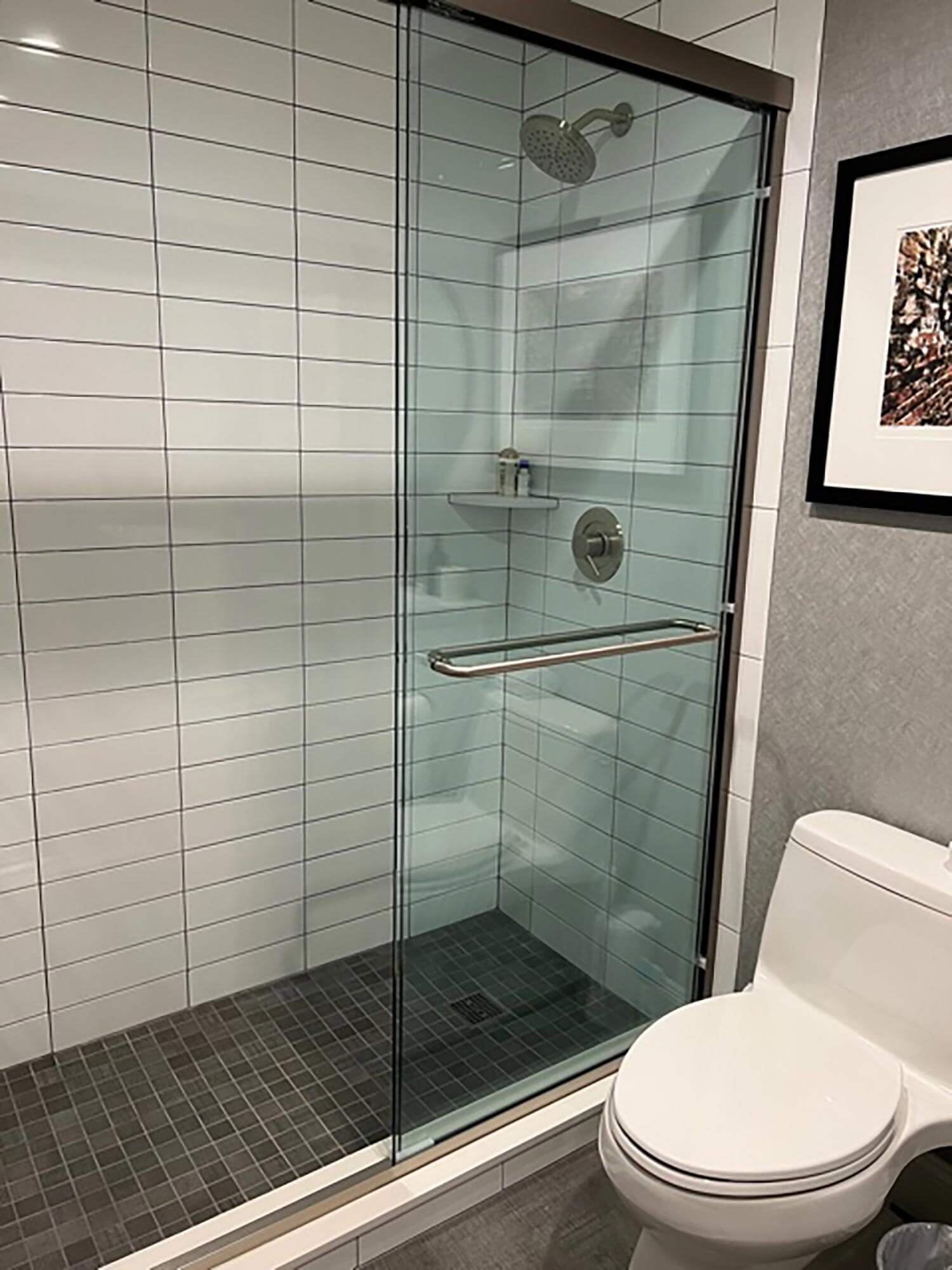 A shower cabin with subway tiles stacked horizontally