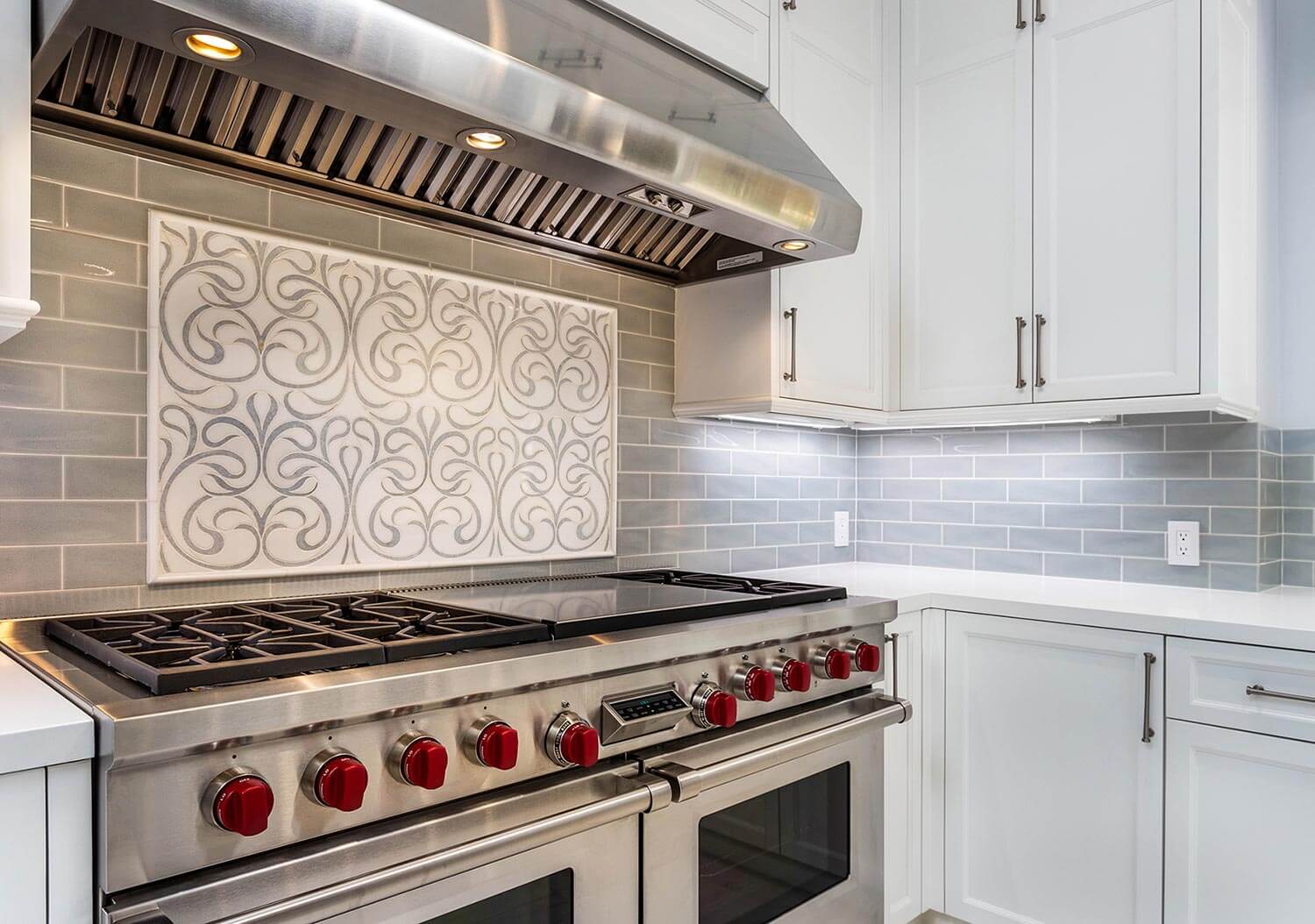 A white kitchen with gray subway tiles
