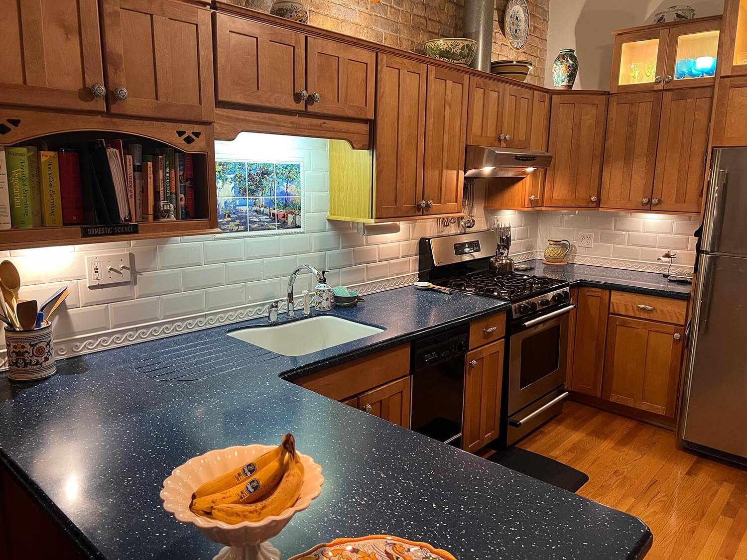 A wooden kitchen with a mixture of tiles