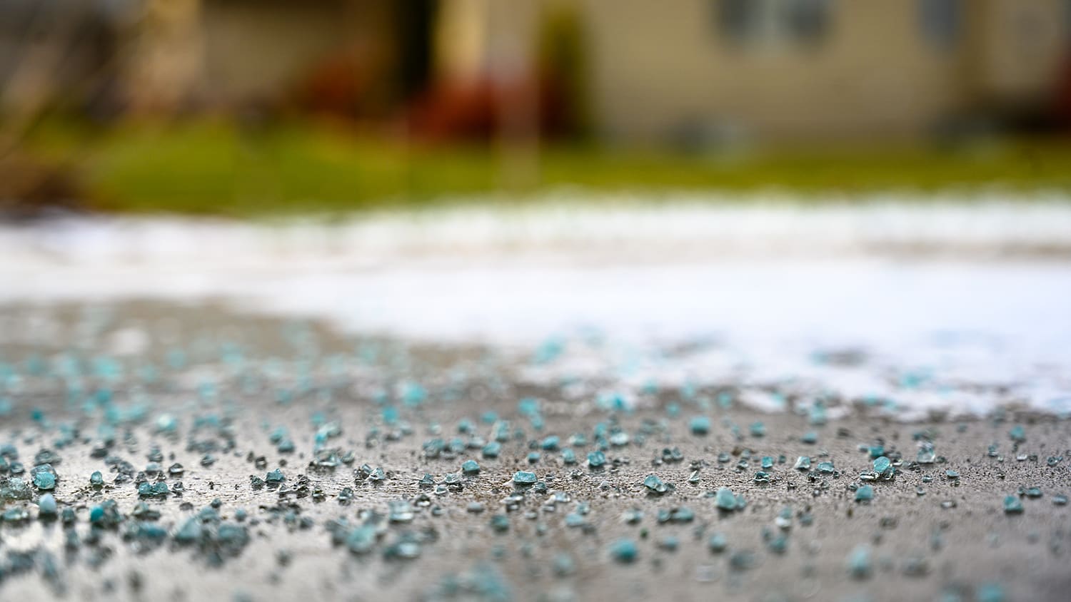 Rock salt melting ice on concrete