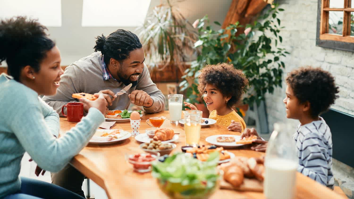 A family of four having lunch at their dining table