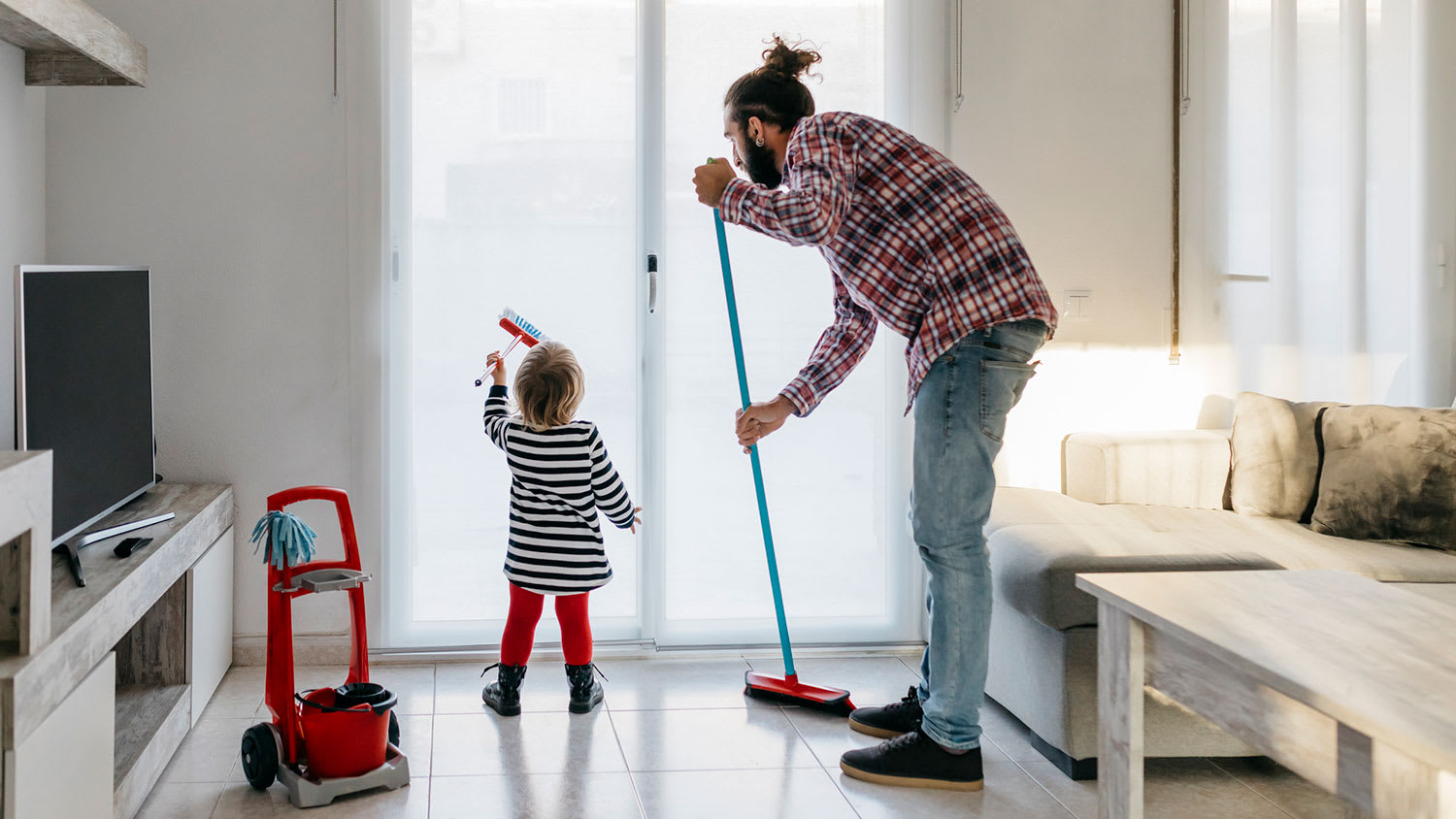 Little girl helping dad cleaning home