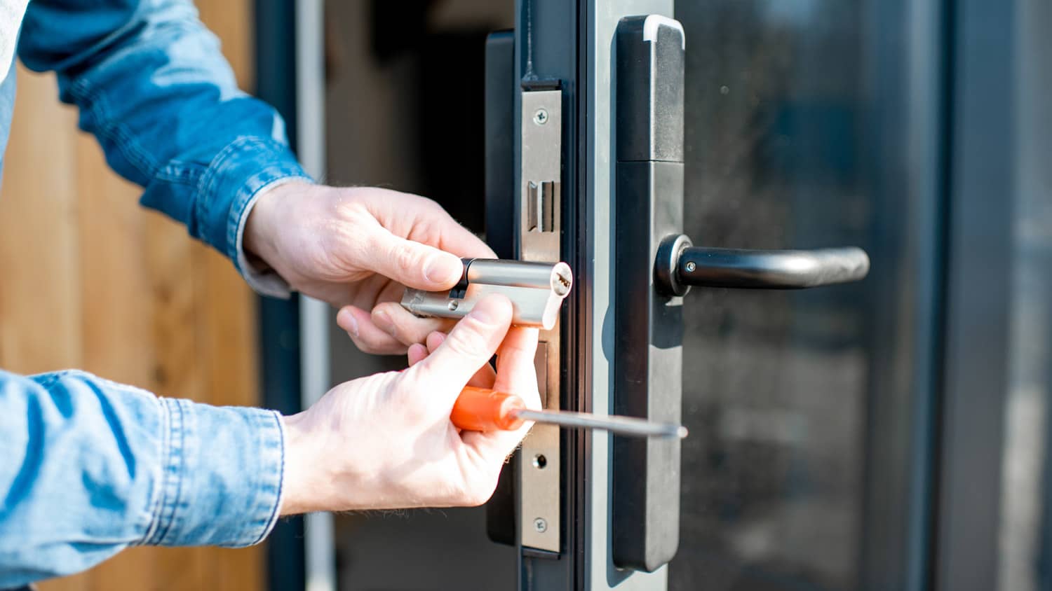 A locksmith changing the locks of a house