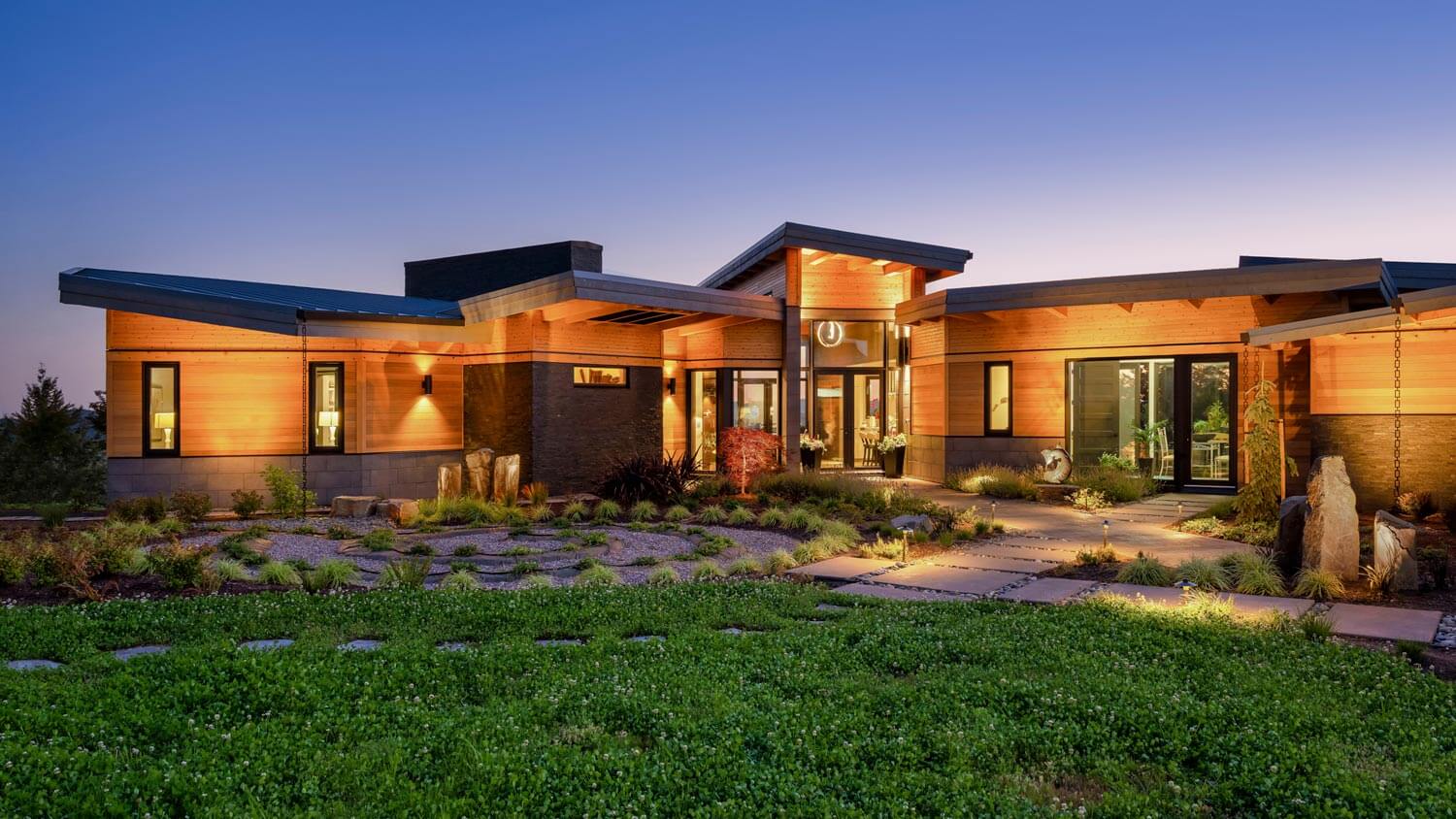 A modern house illuminated at dusk