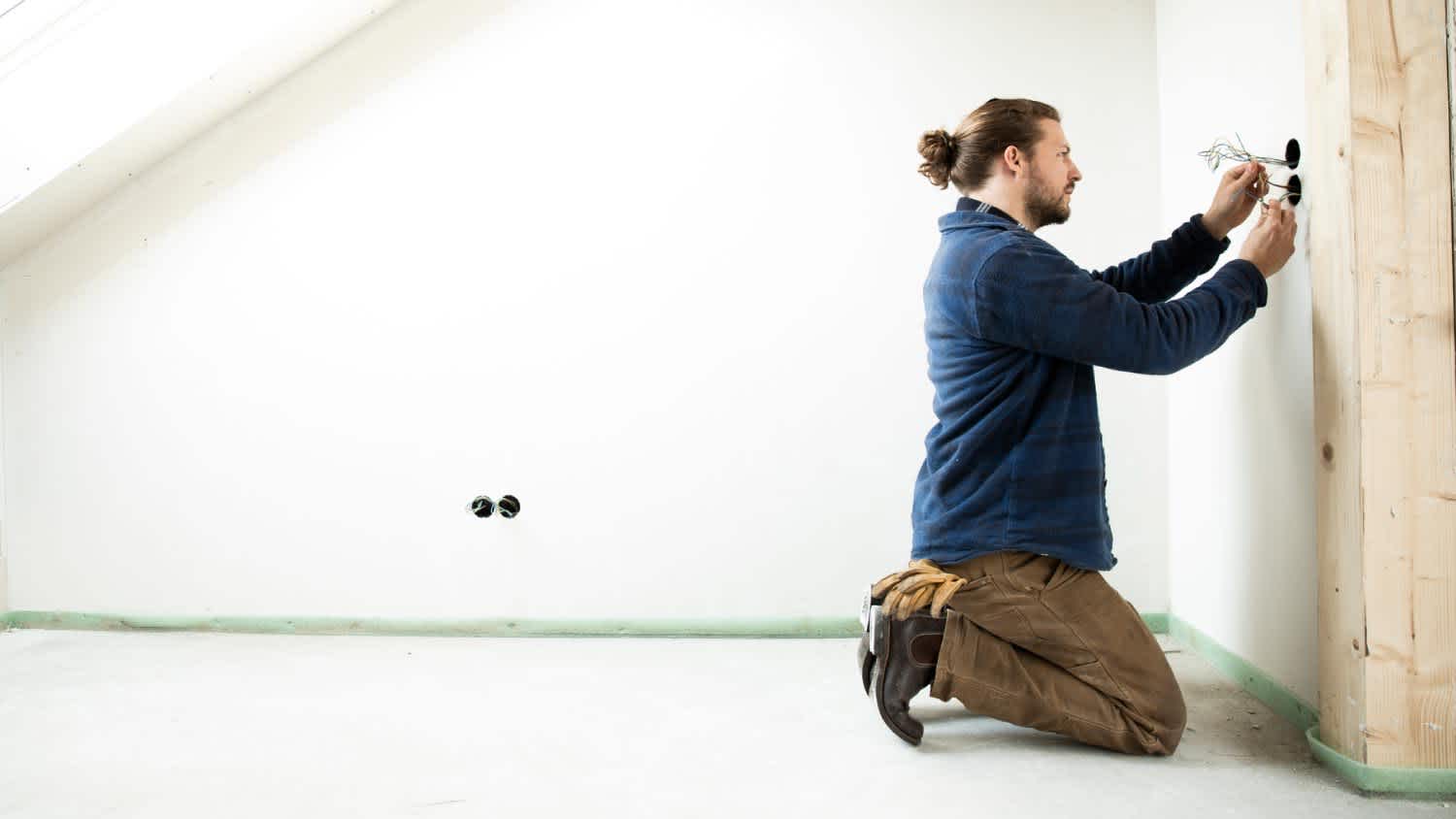 A man installing wires in renovating house