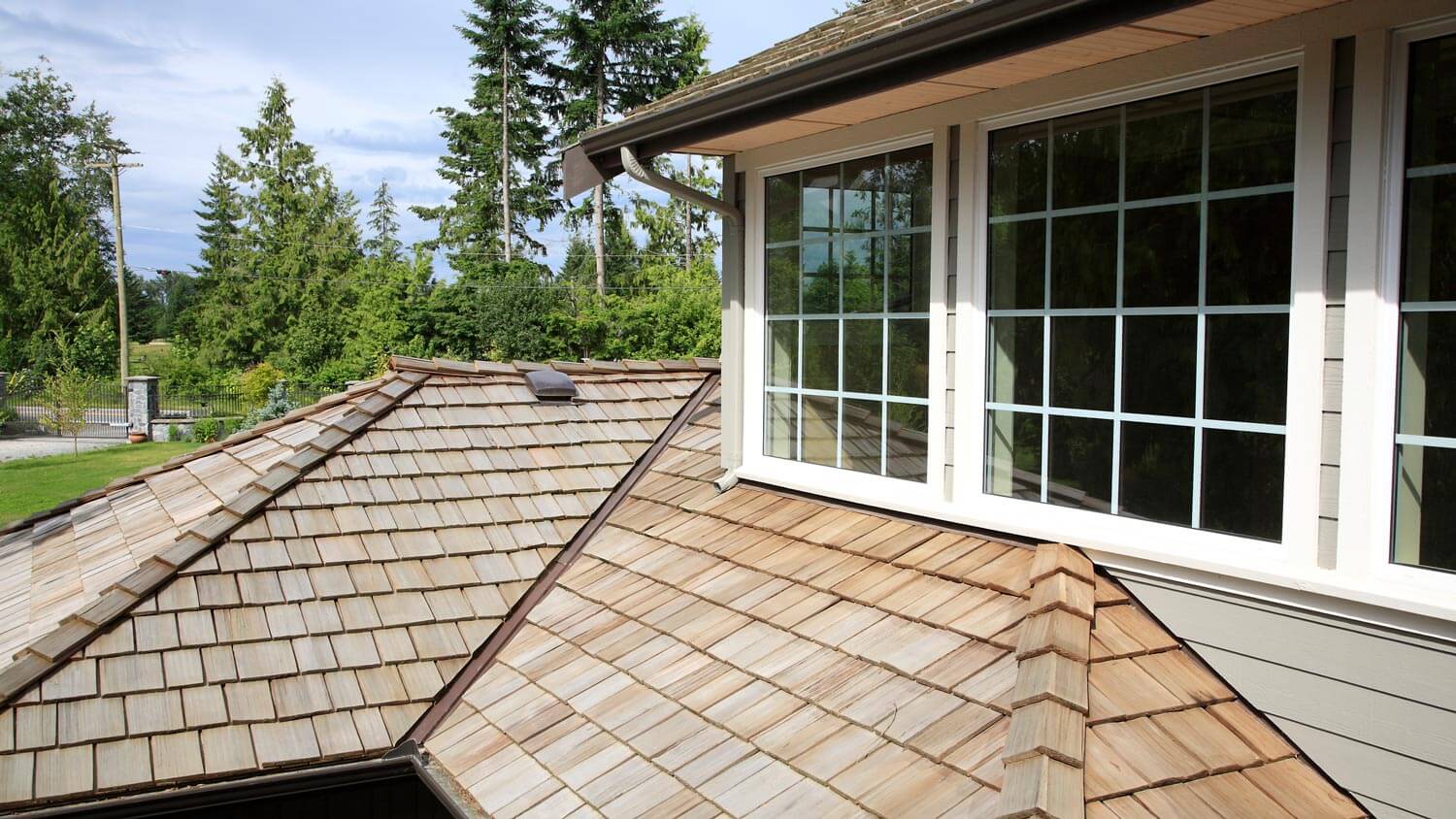 A newly installed roof with cedar shake shingles