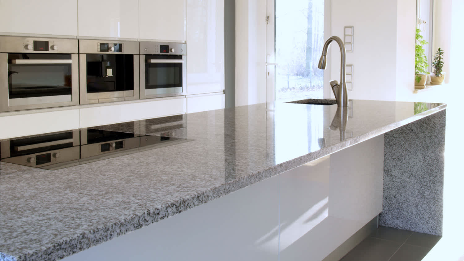 A granite countertop in a modern kitchen