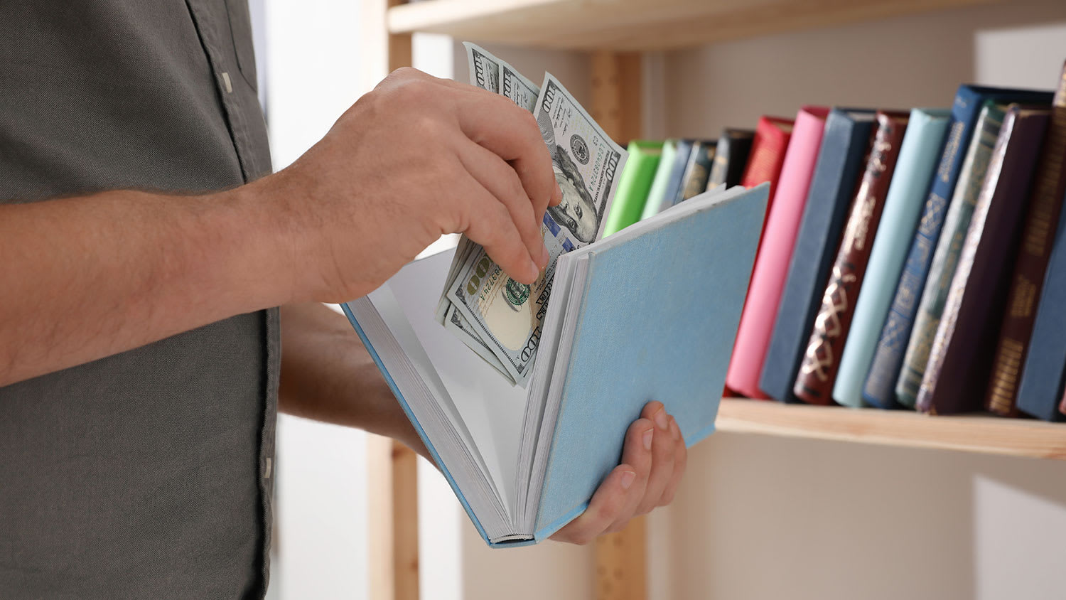 Man hiding cash in a book