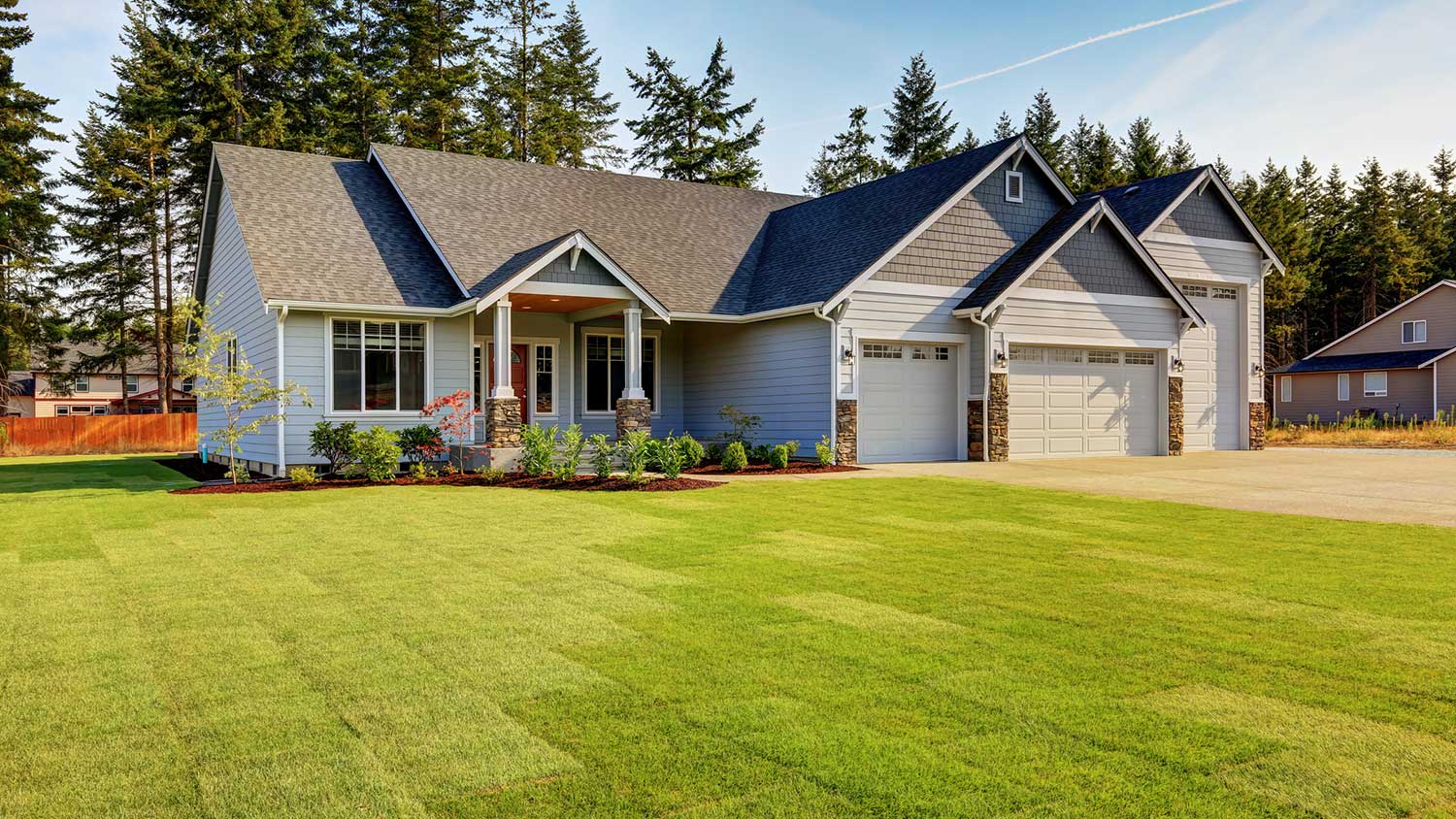 Gray suburban home with large front yard
