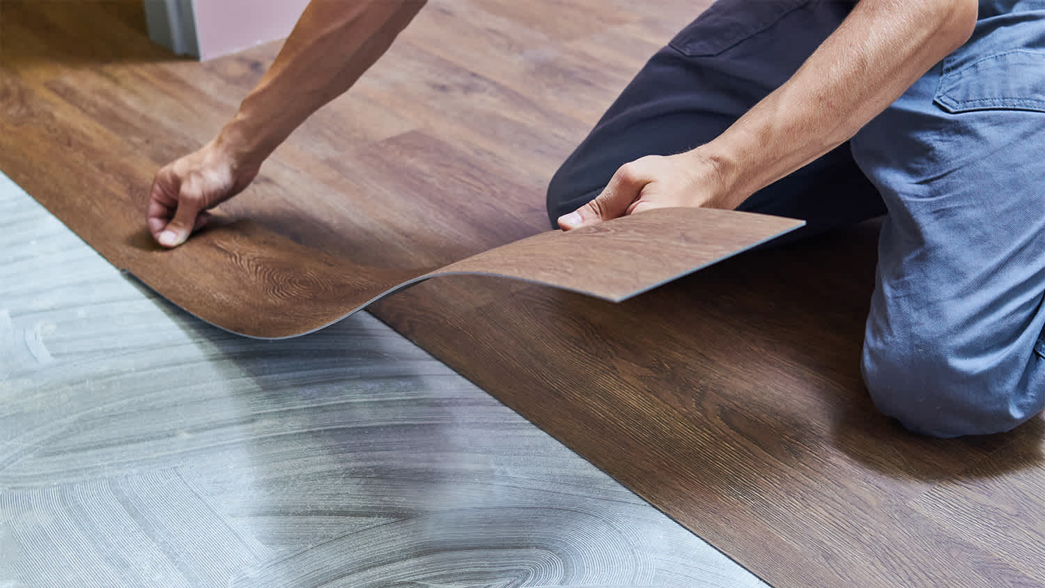 A man installing laminate flooring