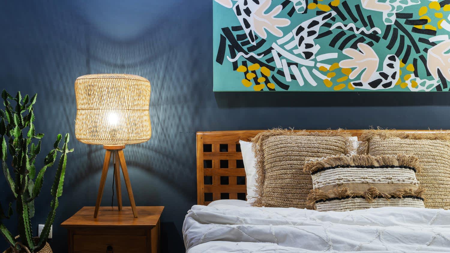 A bedside table lamp in a boho bedroom