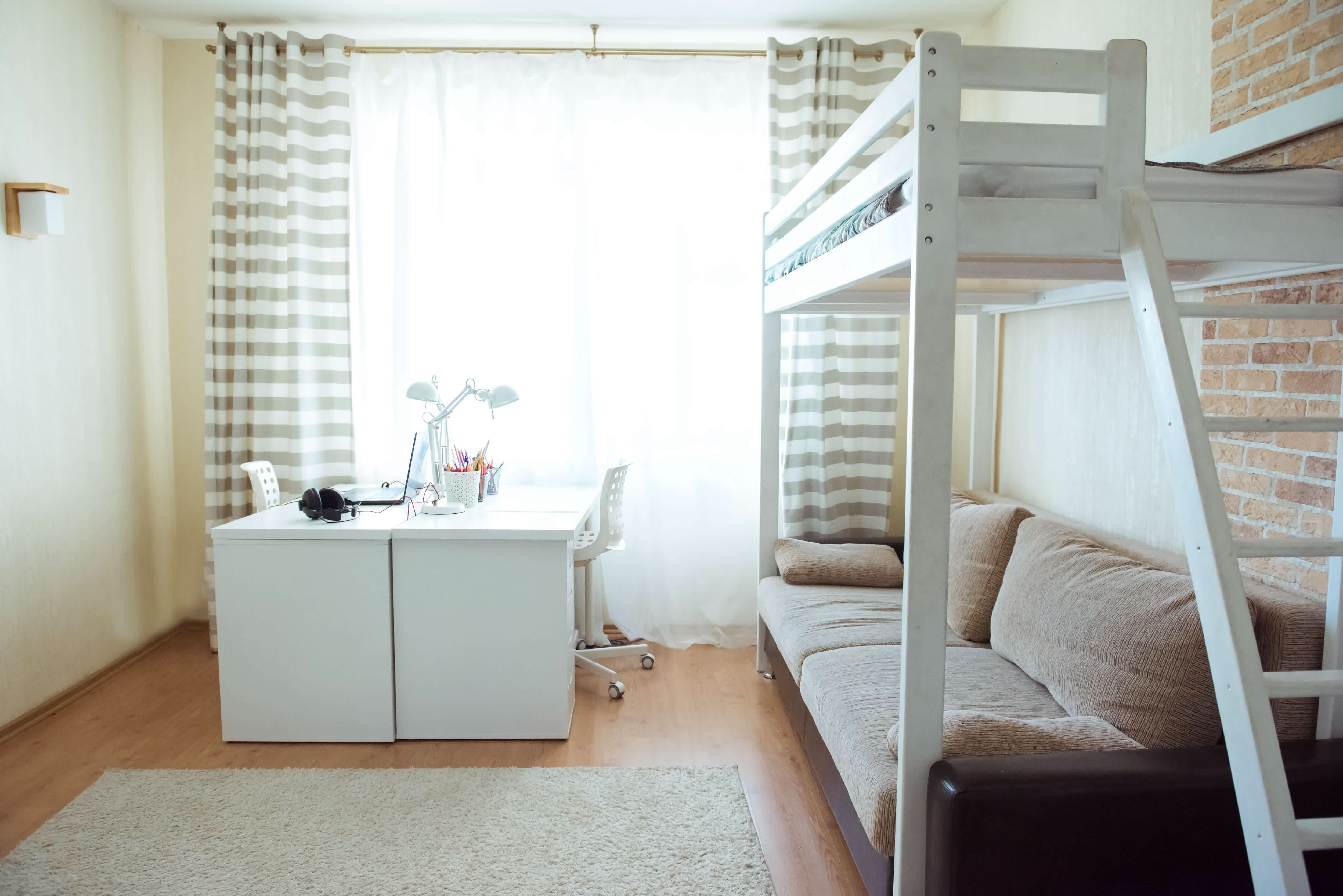 Room with desk, bunk bed, and sofa