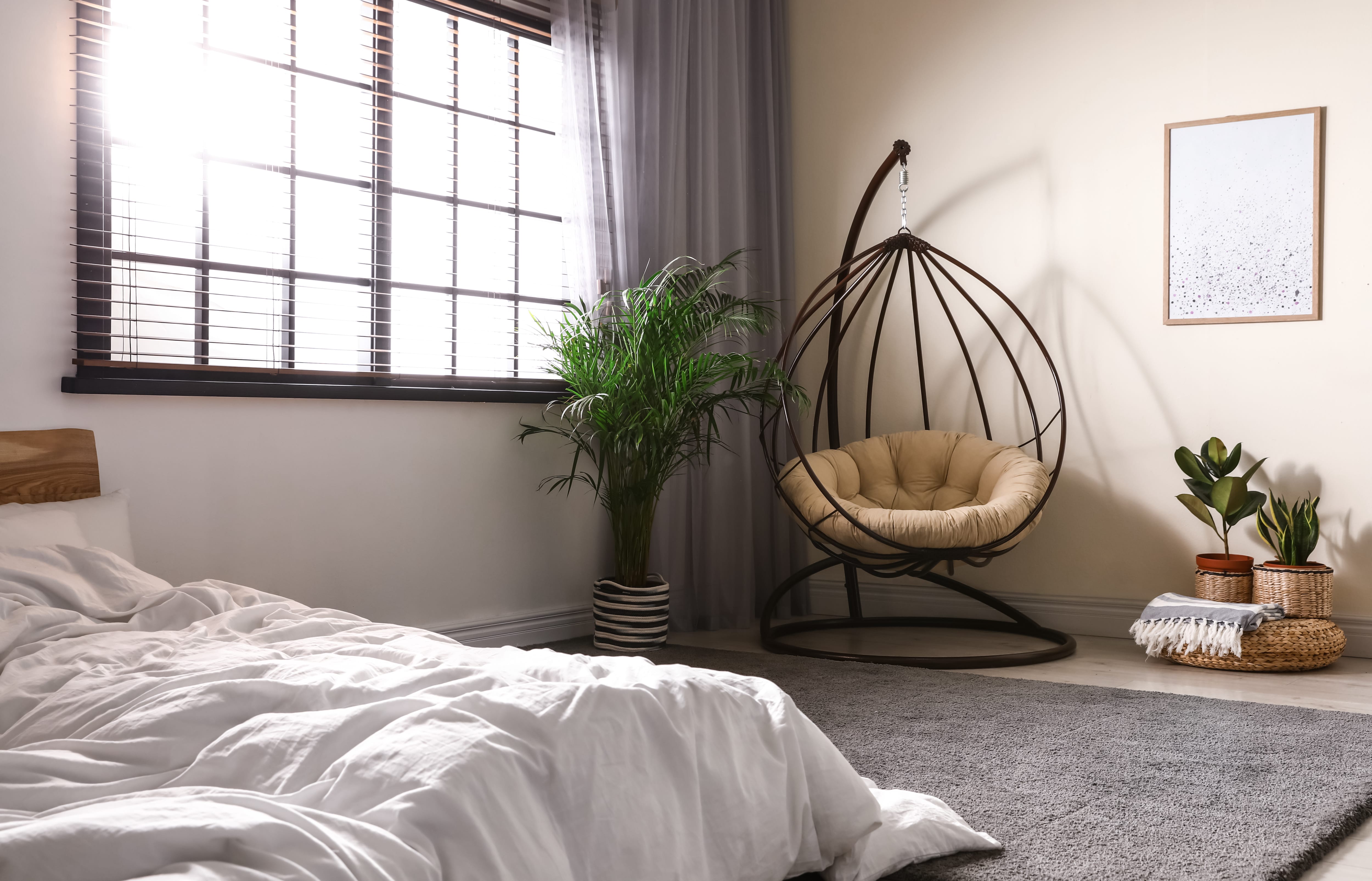Bedroom with egg-shaped swing chair in the corner