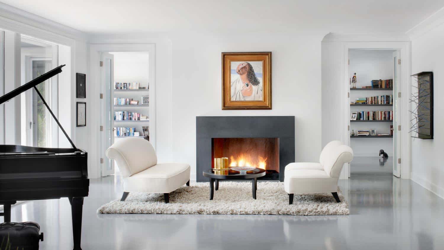 A modern white living room with fire place