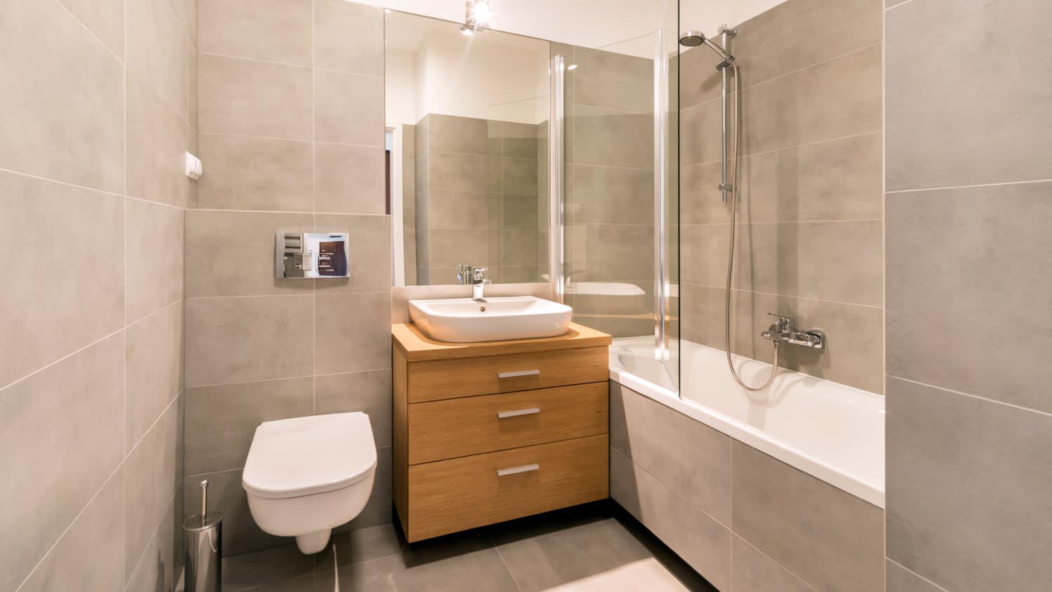 A modern bathroom with tiles on the floor