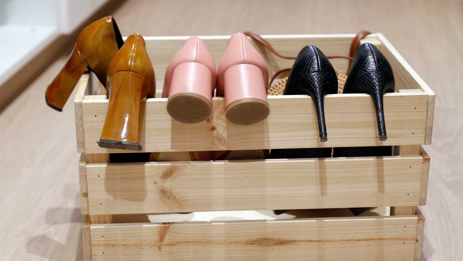 Three pairs of heeled shoes in a box