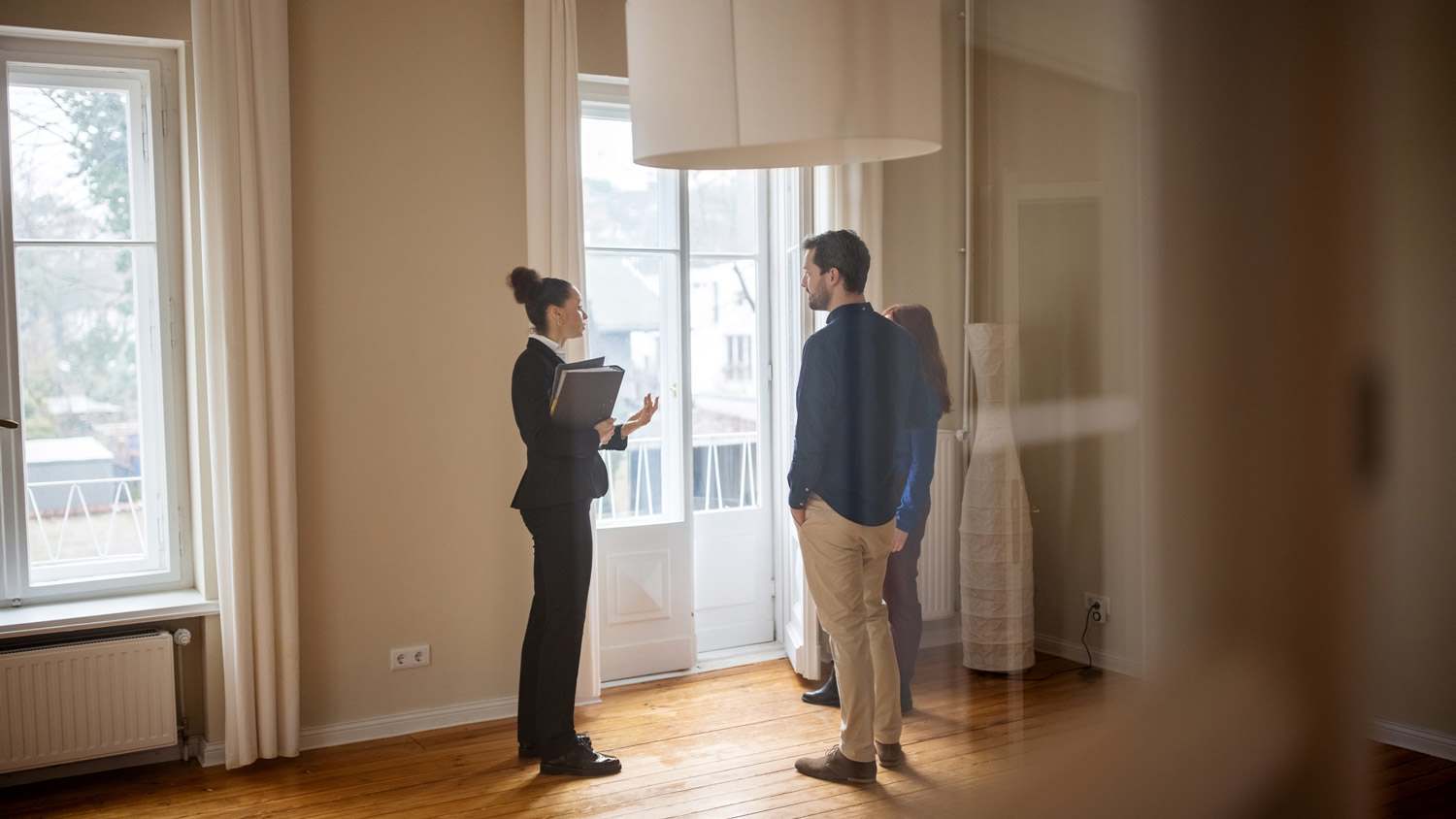Realtor shows home owners around house