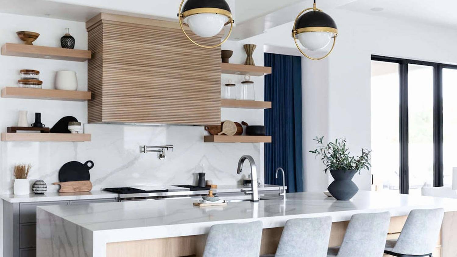 A kitchen with a waterfall edge quartz countertop