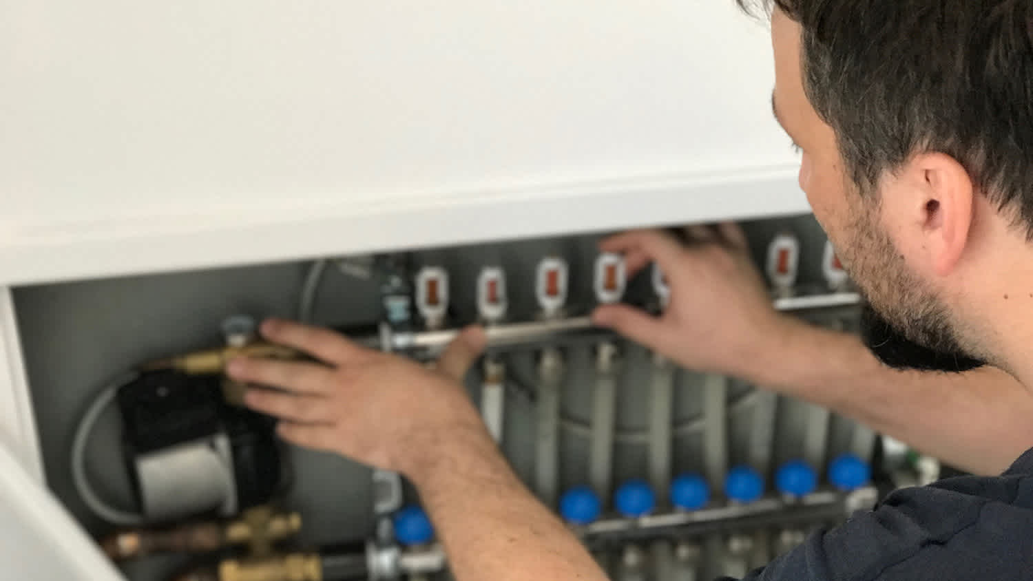 A professional inspecting a heat pump