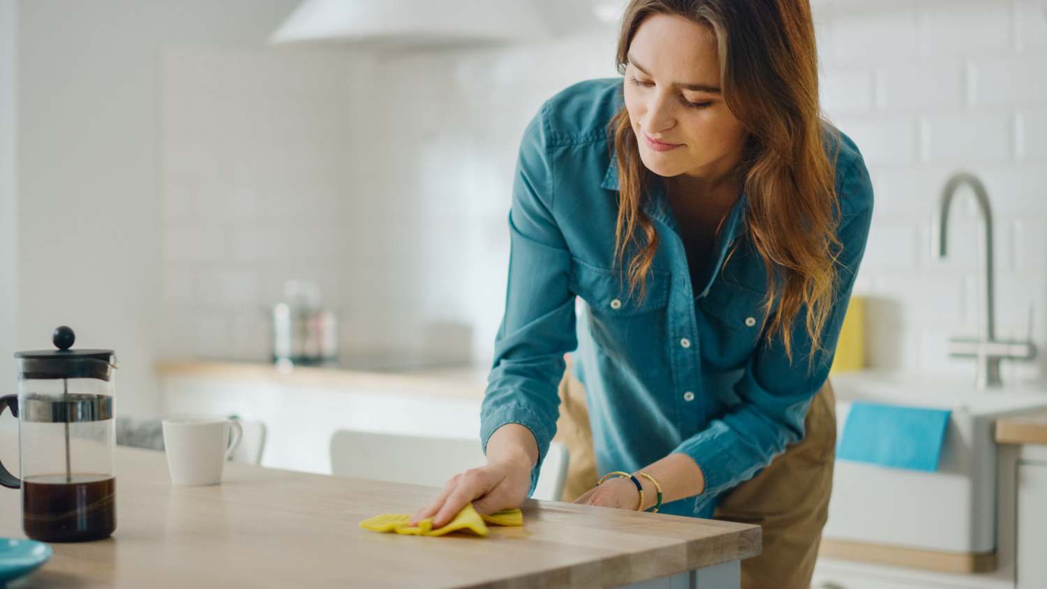 Woman cleans of counters in kitchen