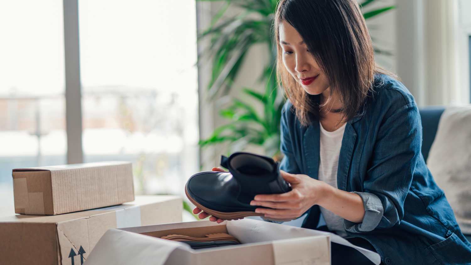 A woman packing a pair of winter boots