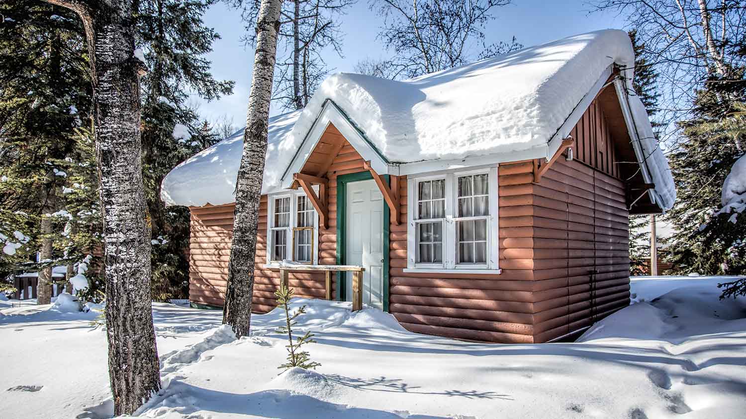 Cabin in the forest covered with snow