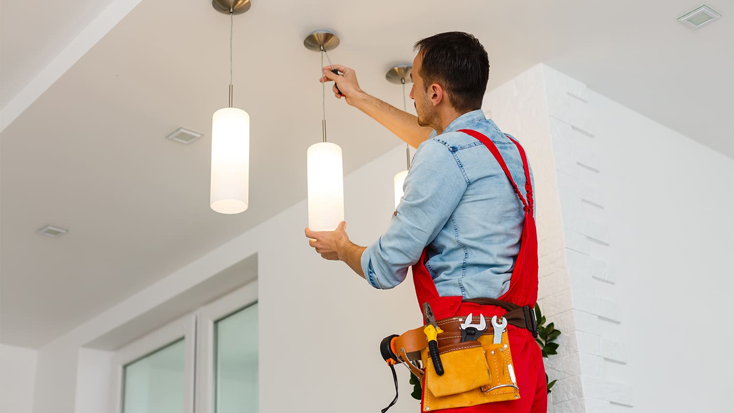 electrician installing ceiling lamp
