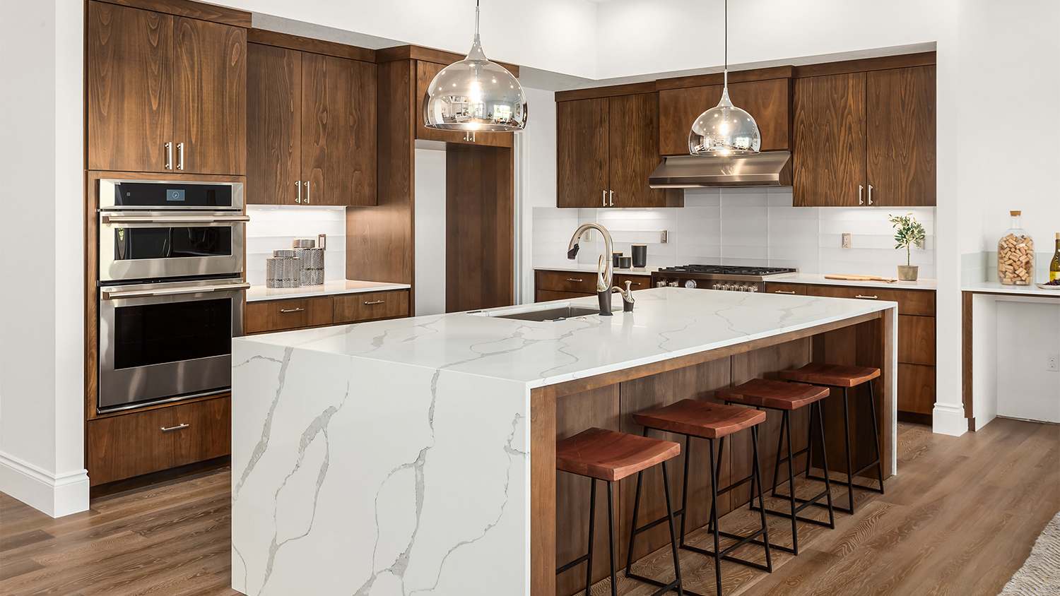 wood kitchen with marble waterfall counter