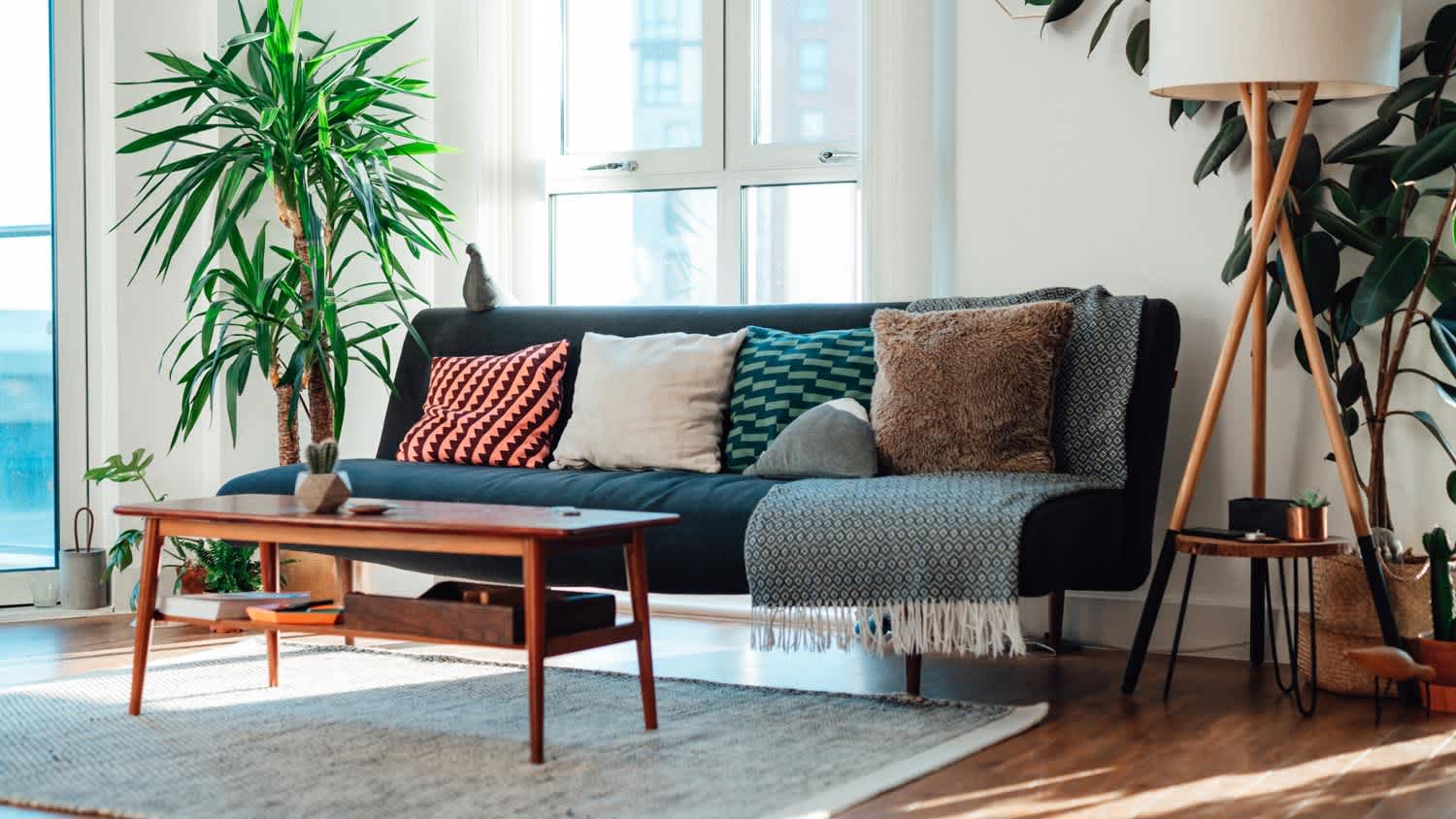 Darkwood floor with a light rug in a living room