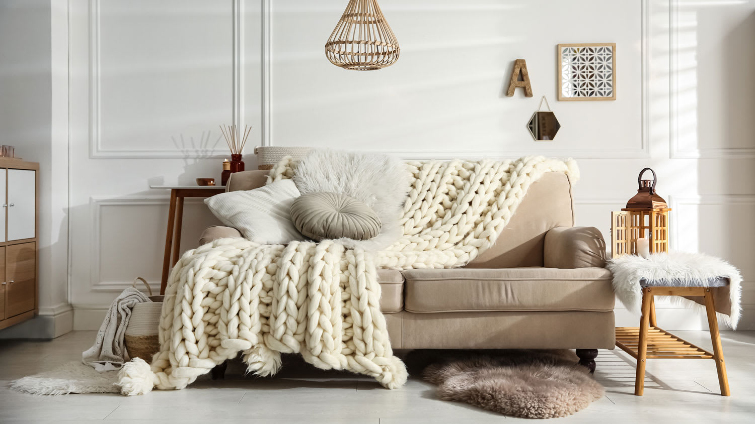 A living room with a blanket on a sofa