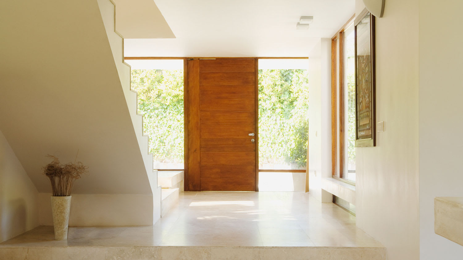A modern hallway with a wooden entry door