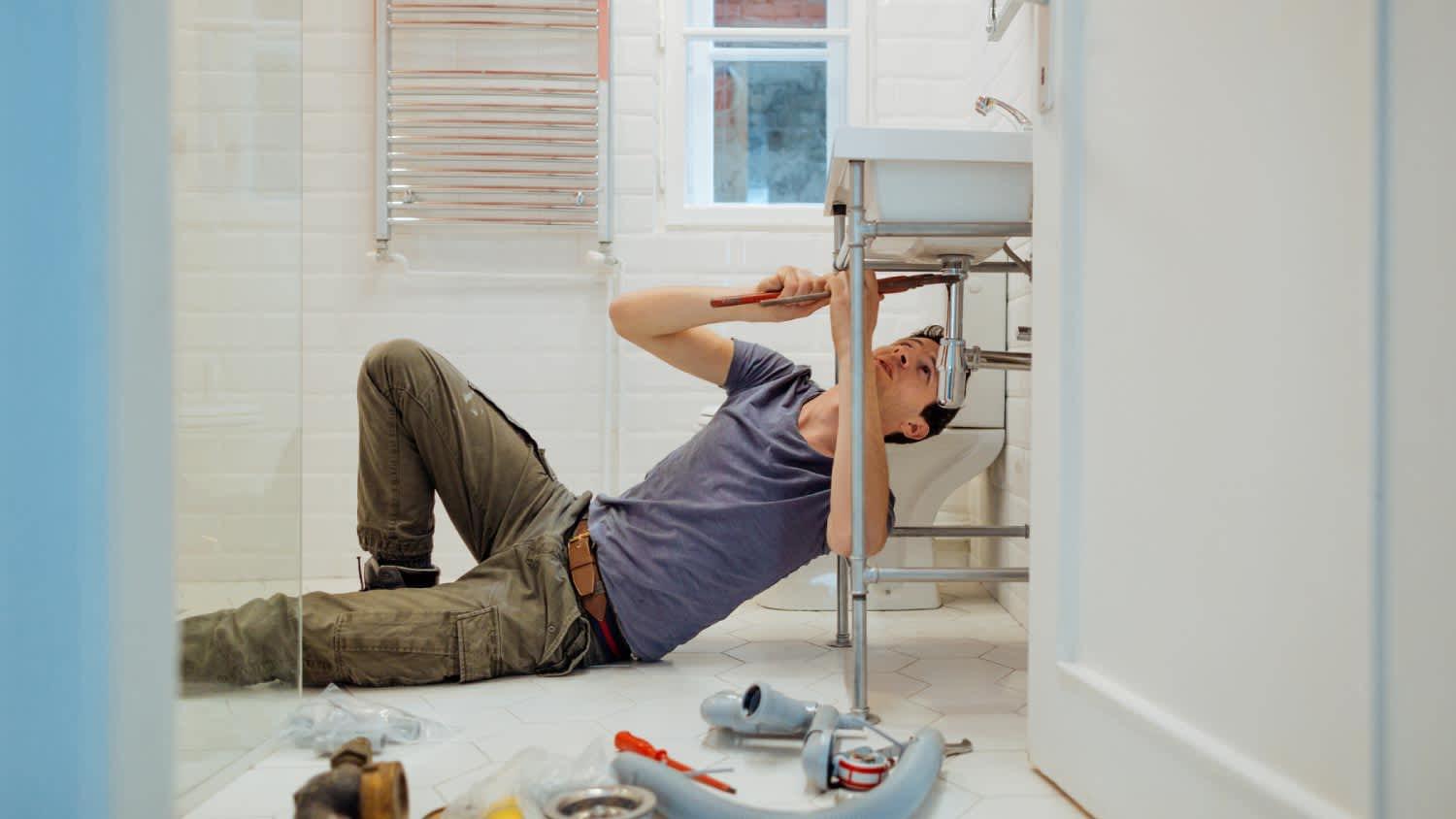 A plumber solving problems in the bathroom