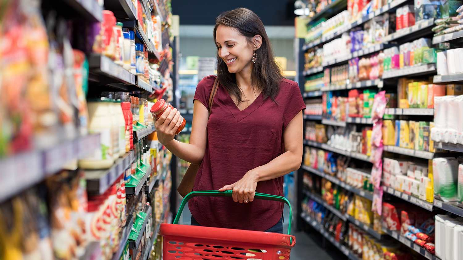 woman reading label in supermarket