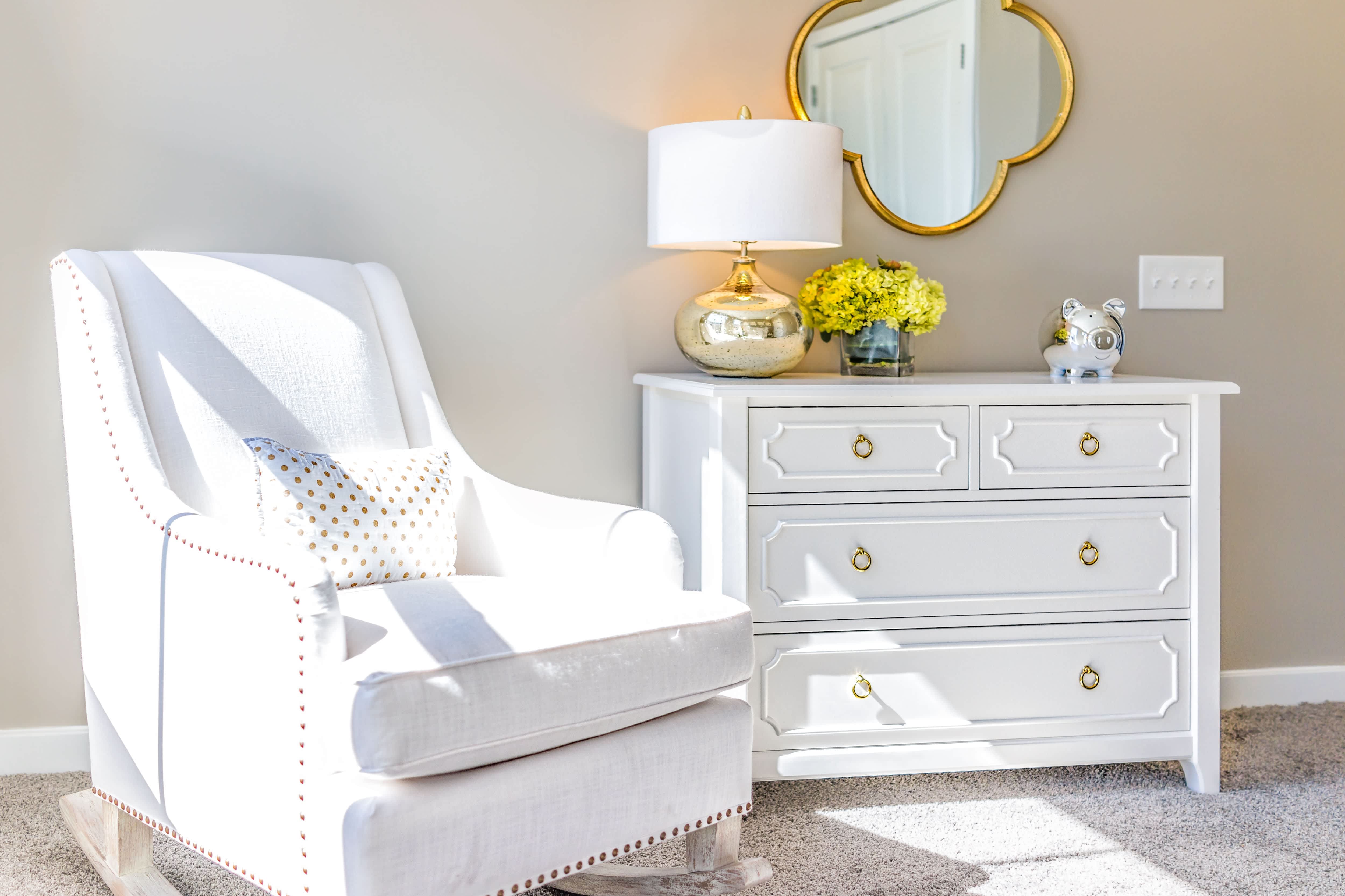 Nursery with comfortable white rocking chair