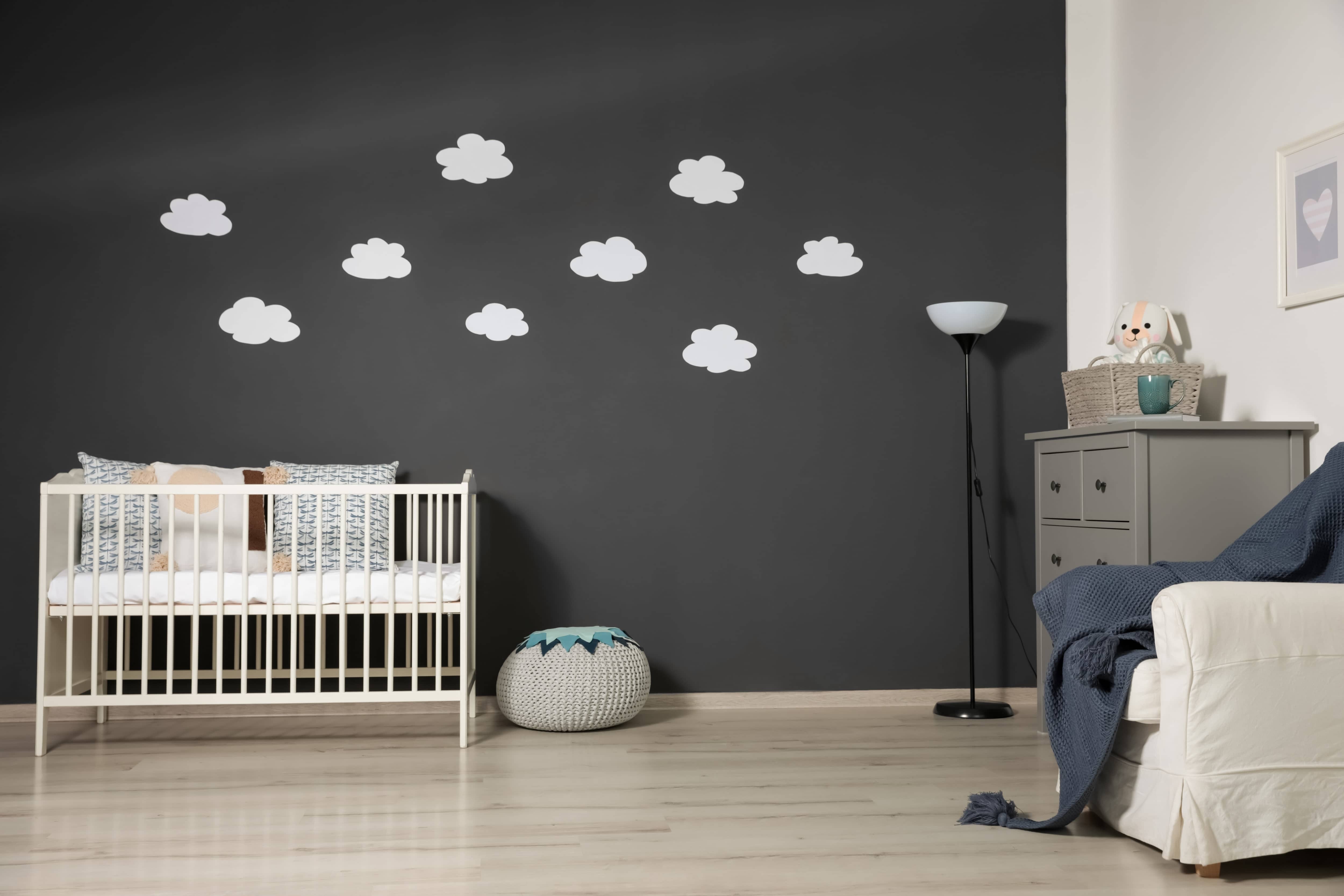 nursery with cloud prints on a black wall