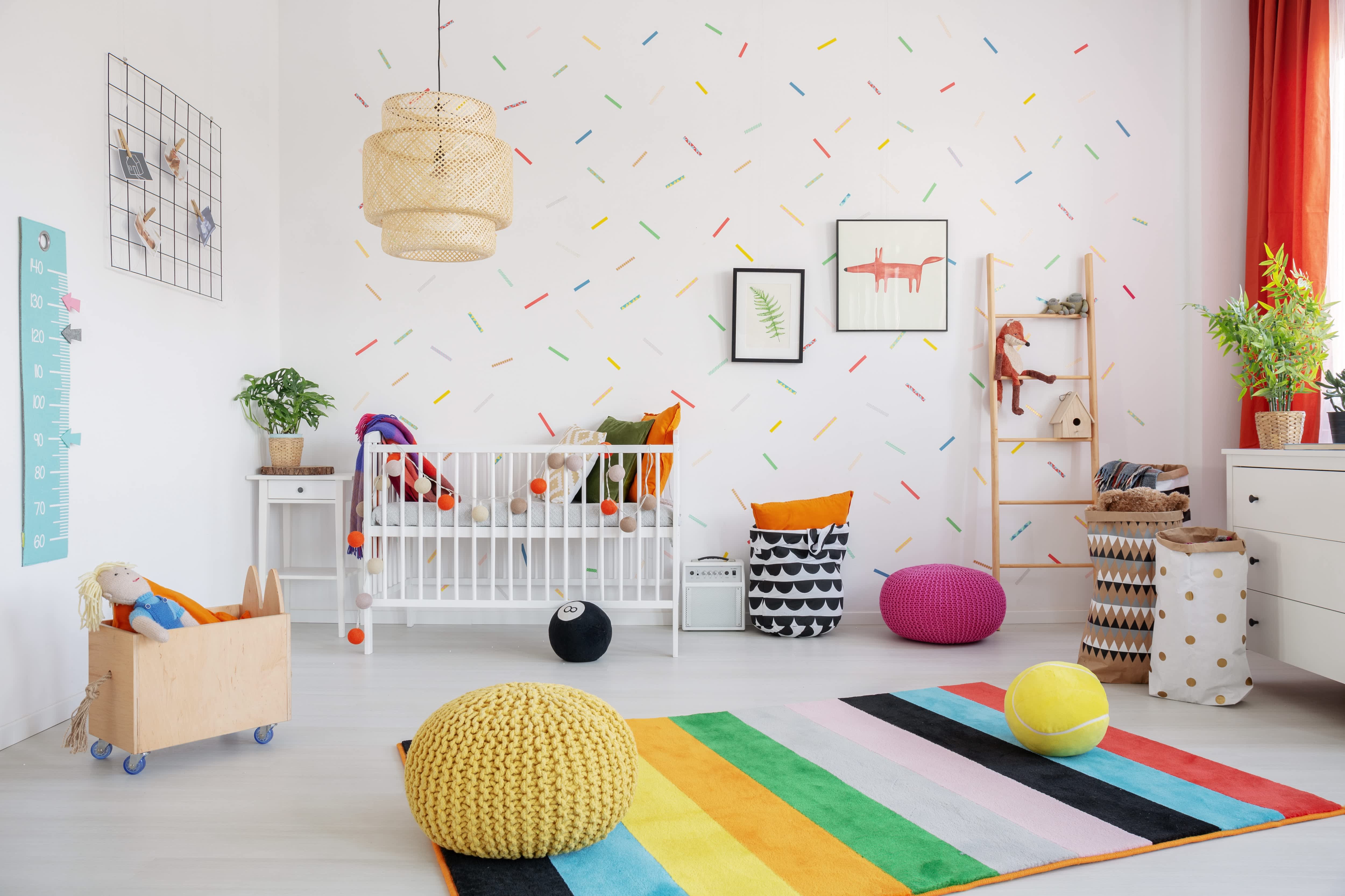 Nursery with colorful rug and wallpaper