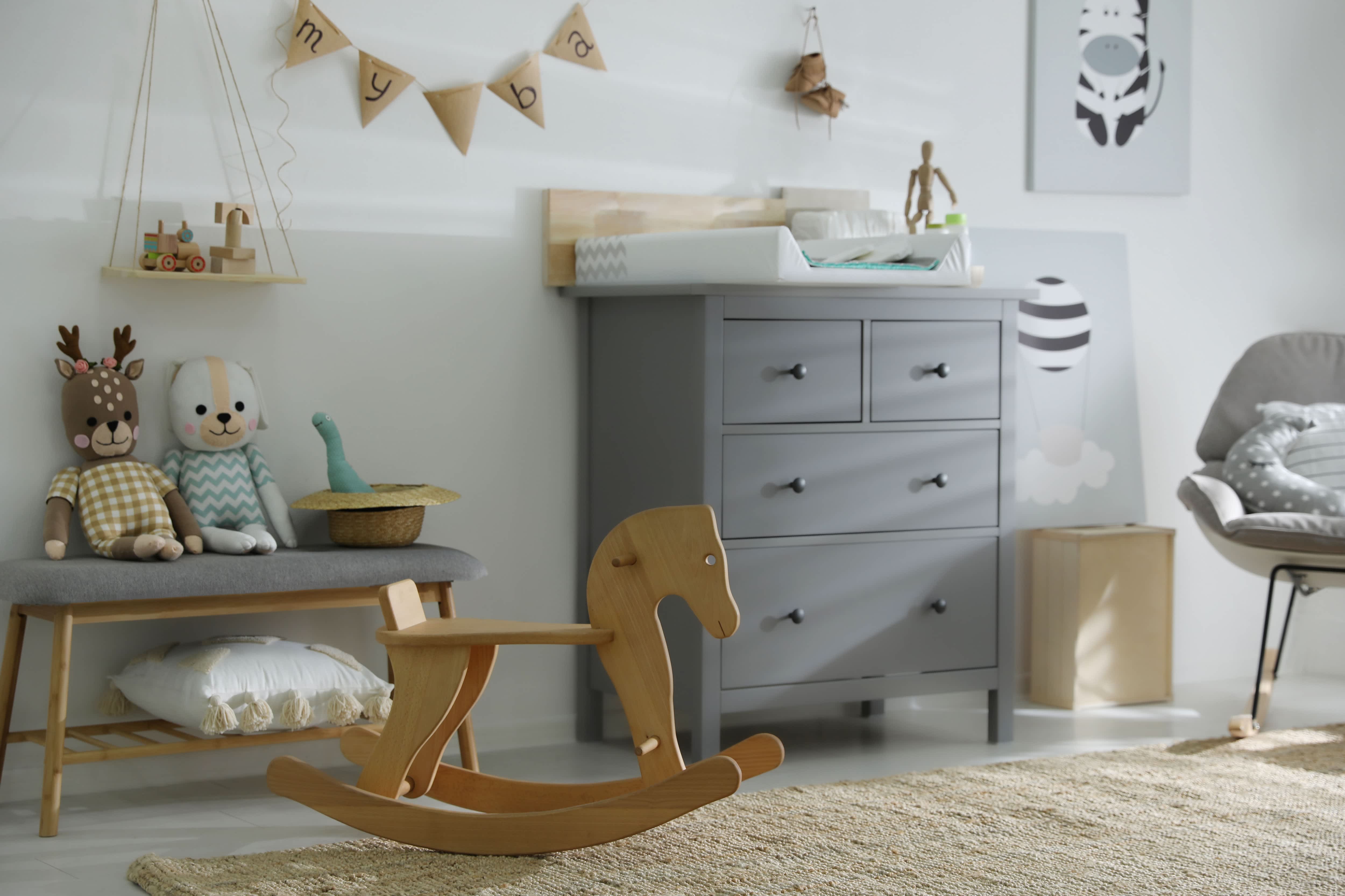 nursery with gray accents and gray storage bench