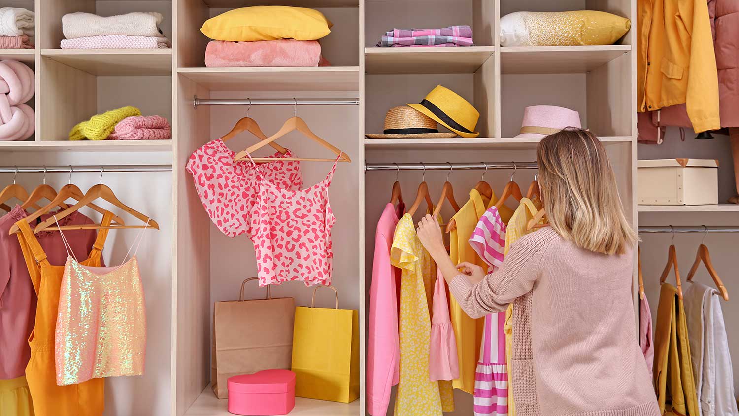 Woman organizing clothes in a large closet