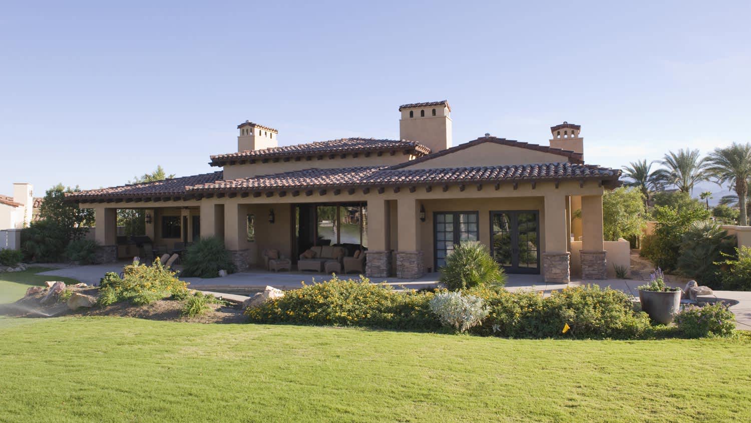 A sunlit garden of a beautiful house on a sunny day