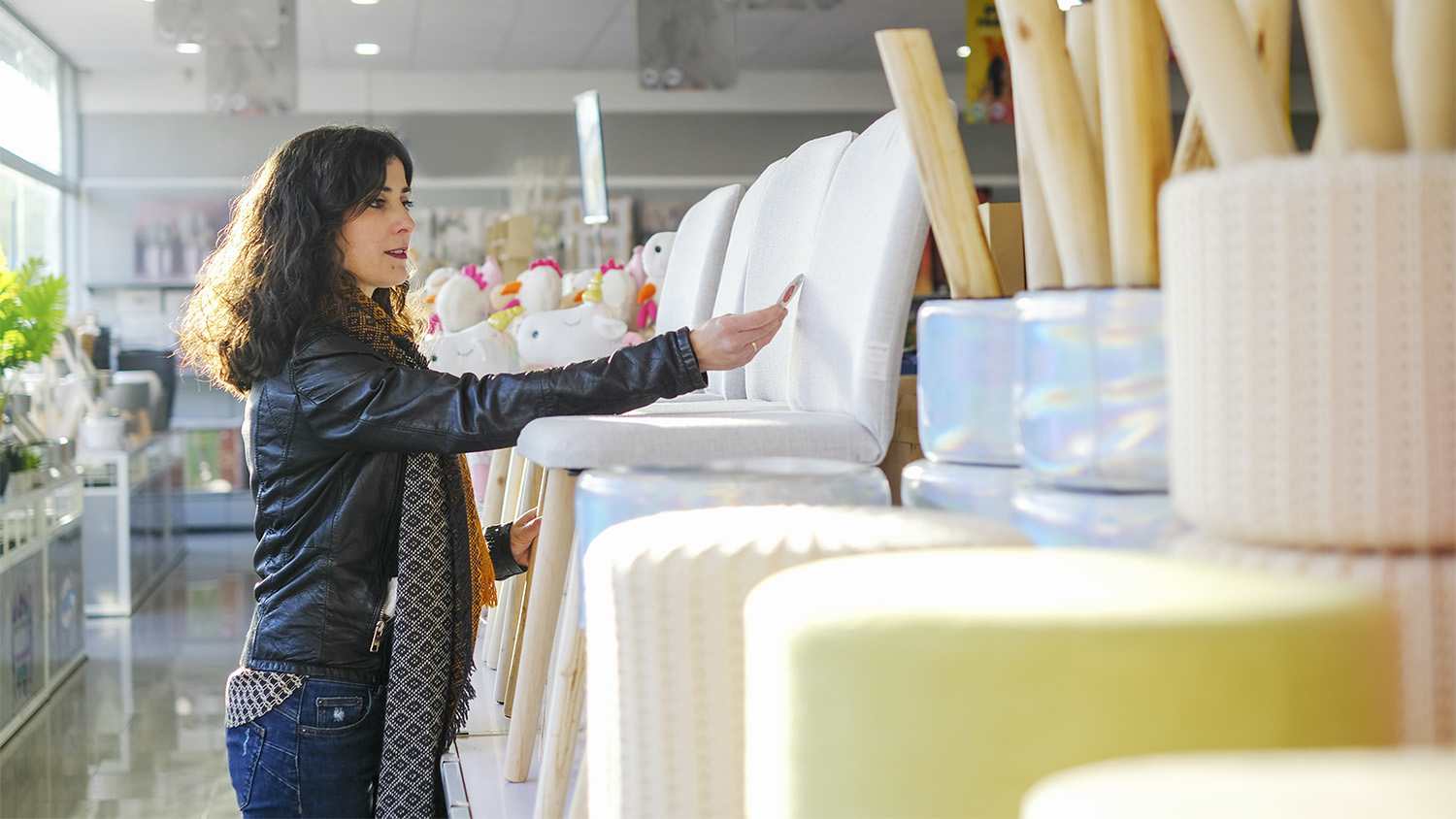 woman looking at a chair in furniture store