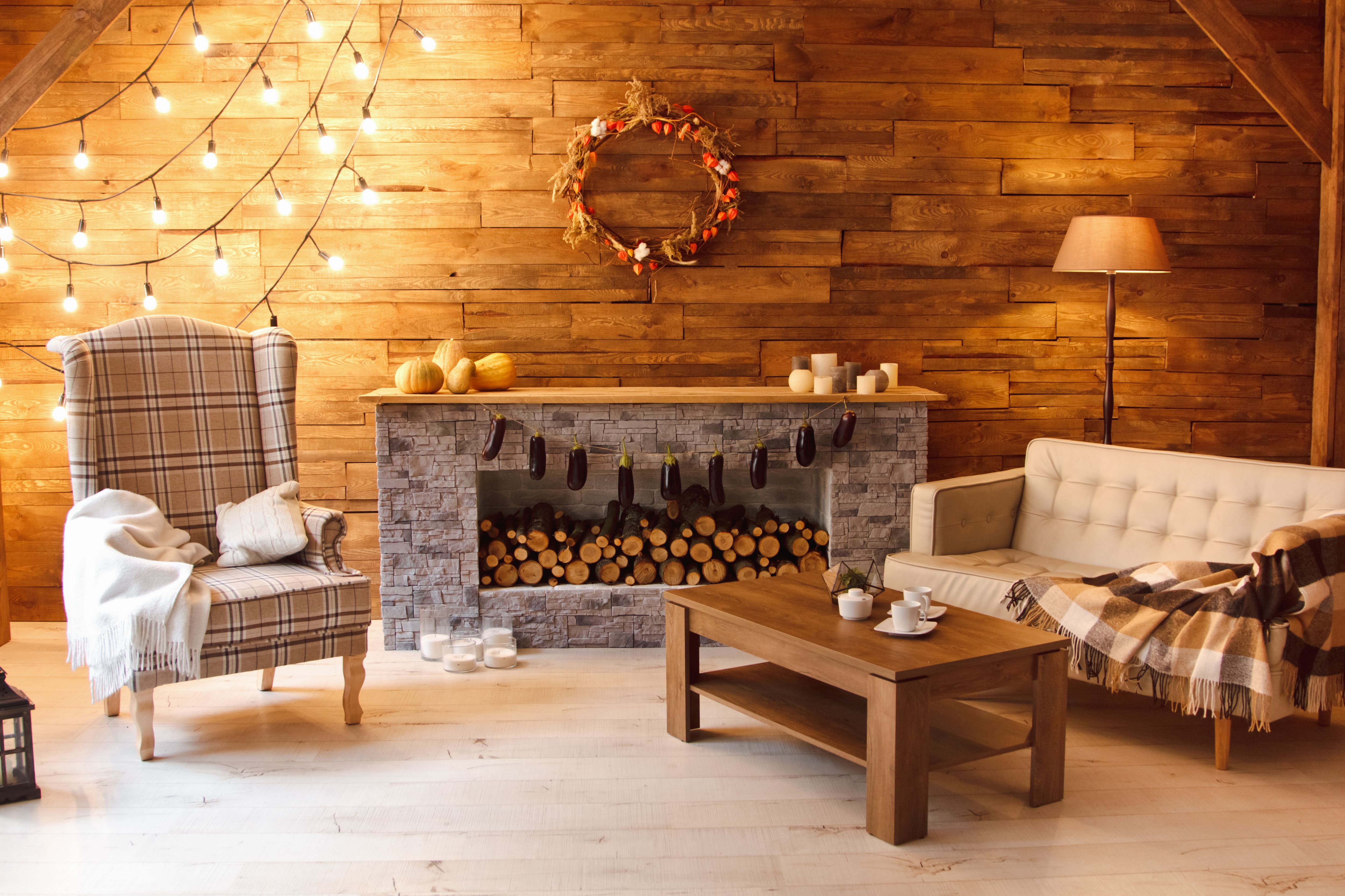 Fireplace mantel decorated with pumpkins and candles